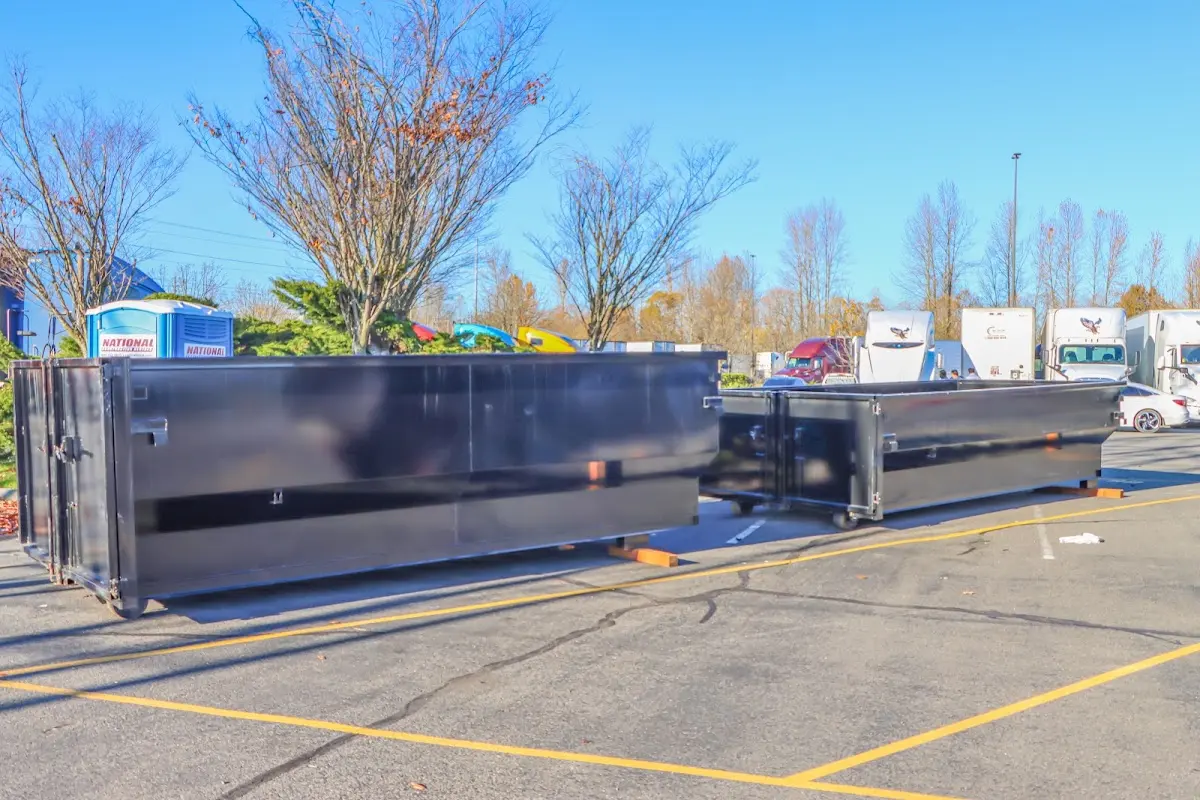 Professional dumpster rental service with roll-off container on residential driveway in Blue Island